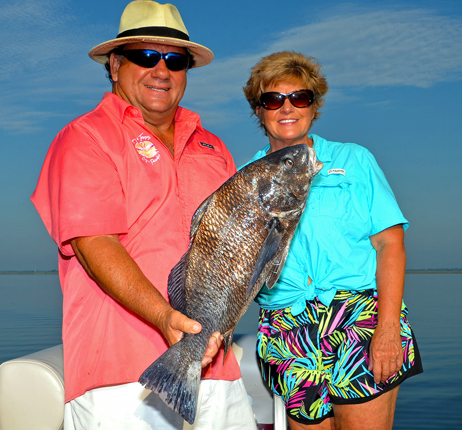 Timmy and Terese Molinere of Timmy and Terese’s Cajun Paradise Lodge show off a black drum caught while fishing in Montegut. (Photo by John N. Felsher)